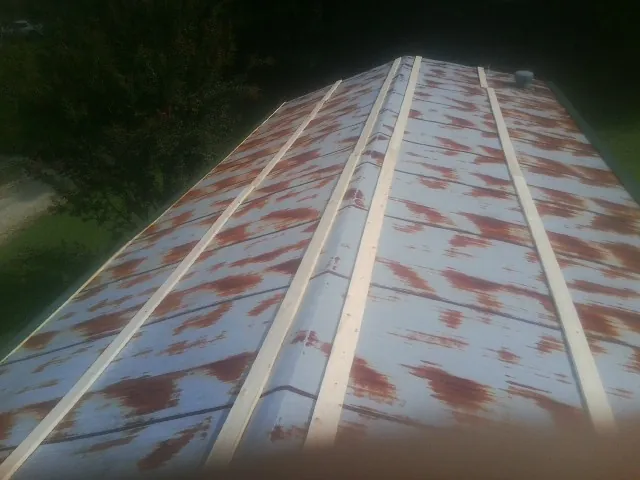 Rusted metal roof panels with new wood purlins before replacement — Storm Damage Roof Repair in Rubicon by Roofing Brothers